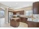 Well-lit kitchen features granite countertops, stainless steel appliances, and a functional center island at 21960 N 70Th Dr, Glendale, AZ 85310