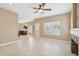 Open concept living room with tile flooring leading to the kitchen at 21960 N 70Th Dr, Glendale, AZ 85310