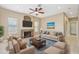 Cozy living room with a stone fireplace, ceiling fan and comfortable seating at 21960 N 70Th Dr, Glendale, AZ 85310