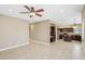 Living room featuring tile flooring and a ceiling fan that leads to the kitchen at 21960 N 70Th Dr, Glendale, AZ 85310