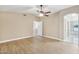 This main bedroom has hardwood floors, a ceiling fan and an en suite bathroom at 21960 N 70Th Dr, Glendale, AZ 85310