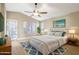 Beautifully staged main bedroom features a ceiling fan and an outside entrance at 21960 N 70Th Dr, Glendale, AZ 85310