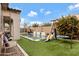 View of the backyard oasis, complete with pool, artificial grass, and a playset, perfect for Gathering fun at 22854 E Sonoqui Blvd, Queen Creek, AZ 85142