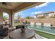 Spacious covered patio area overlooking the pool, complete with outdoor seating, perfect for relaxing and entertaining at 22854 E Sonoqui Blvd, Queen Creek, AZ 85142