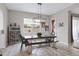 Bright dining room with a modern farmhouse table set and pendant lighting fixture at 22854 E Sonoqui Blvd, Queen Creek, AZ 85142