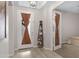 Bright foyer featuring tile flooring, a decorative ladder shelf, and a view into the bedroom at 22854 E Sonoqui Blvd, Queen Creek, AZ 85142