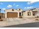 Inviting single-story home with a two-car garage, desert landscaping, and well-maintained front yard at 22854 E Sonoqui Blvd, Queen Creek, AZ 85142