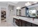 Elegant main bathroom with double vanity, modern mirrors, and glass-enclosed shower at 22854 E Sonoqui Blvd, Queen Creek, AZ 85142