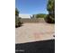 View of the spacious backyard with rock groundcover, block fence, and paving stone pathway at 2634 N Saffron Cir, Mesa, AZ 85215