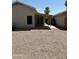 A backyard featuring rock groundcover, with a covered patio and block fence at 2634 N Saffron Cir, Mesa, AZ 85215