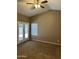 Spacious carpeted bedroom with a ceiling fan and double doors leading to the outdoors at 2634 N Saffron Cir, Mesa, AZ 85215