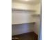 Walk-in closet with multiple shelves and neutral carpet flooring, offering ample storage space at 2634 N Saffron Cir, Mesa, AZ 85215