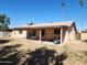 House exterior featuring a patio, backyard, palm trees and some lawn furniture at 2839 W Villa Maria Dr, Phoenix, AZ 85053