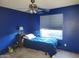 Bedroom with blue walls, window, ceiling fan, and bed at 2839 W Villa Maria Dr, Phoenix, AZ 85053