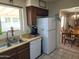 Well-lit kitchen with ample counter space, essential appliances, and a view into the dining area at 2839 W Villa Maria Dr, Phoenix, AZ 85053