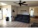 Open-concept living room with a comfortable sofa, tiled flooring, and a ceiling fan at 2839 W Villa Maria Dr, Phoenix, AZ 85053