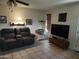 Inviting living room with a comfortable sofa, a ceiling fan, and a TV for entertainment at 2839 W Villa Maria Dr, Phoenix, AZ 85053