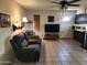 Spacious living room with comfortable seating, a ceiling fan, and a view into the kitchen area at 2839 W Villa Maria Dr, Phoenix, AZ 85053