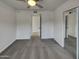 Bedroom with carpet, ceiling fan, sliding door closet, and doorway leading to another room at 3009 W Laurel Ln, Phoenix, AZ 85029