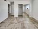 Well-lit empty room features neutral tile floor, walk-in closet, and fresh, white paint at 3009 W Laurel Ln, Phoenix, AZ 85029