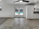 Bright living room with tiled floor and French doors opening to the pool area at 3009 W Laurel Ln, Phoenix, AZ 85029