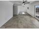 Spacious living room with tile flooring, ceiling fan, and a glass door leading to the yard at 3009 W Laurel Ln, Phoenix, AZ 85029