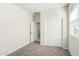 Bedroom with carpet floors, sliding closet doors, and plenty of natural light at 35621 W San Alvarez Ave, Maricopa, AZ 85138