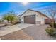 Charming front exterior showcasing a brown garage door, desert landscaping, and a concrete driveway at 35621 W San Alvarez Ave, Maricopa, AZ 85138