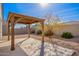 This backyard patio features desert landscaping, a covered patio, and a block wall at 35621 W San Alvarez Ave, Maricopa, AZ 85138