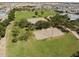 Aerial view of a community park showcasing sport courts and ramada covered playground at 37326 W San Clemente St, Maricopa, AZ 85138