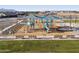 Wide shot of the community playground with slides, benches and covering from sun at 37326 W San Clemente St, Maricopa, AZ 85138