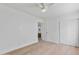 Bright bedroom featuring hardwood floors, a ceiling fan, and a closet at 4131 E Minnezona Ave, Phoenix, AZ 85018