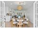 Open dining area with modern lighting and views into the modern kitchen and living room at 4131 E Minnezona Ave, Phoenix, AZ 85018