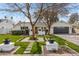 Charming home with a well-manicured lawn, brick pathway, mature trees, and a welcoming front porch at 4131 E Minnezona Ave, Phoenix, AZ 85018