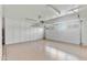 Well-organized garage with epoxy flooring, bright lighting, and plenty of built-in storage cabinets at 4131 E Minnezona Ave, Phoenix, AZ 85018