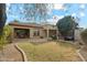 Landscaped backyard featuring gravel, grass, stone, and a covered sitting area at 4284 N 154Th Ave, Goodyear, AZ 85395