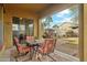 A cozy covered patio seating area features a table and four chairs at 4284 N 154Th Ave, Goodyear, AZ 85395