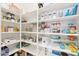 Organized walk-in pantry featuring white shelving stocked with various food items and kitchen essentials at 4284 N 154Th Ave, Goodyear, AZ 85395