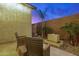 Private backyard oasis with elegant desert landscaping, palm trees, and a modern water feature at 4330 S Neutron --, Mesa, AZ 85212