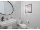 Stylish powder room featuring a unique round mirror and minimalist decor for a modern touch at 4330 S Neutron --, Mesa, AZ 85212