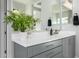 A spacious bathroom featuring dual vanities with modern fixtures, a white countertop, and a decorative plant at 4330 S Neutron --, Mesa, AZ 85212