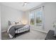 Cozy bedroom featuring a comfortable bed, neutral decor, and natural light from the window at 4330 S Neutron --, Mesa, AZ 85212