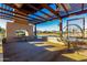 Shaded outdoor seating area featuring a pergola, tables, chairs, and a view of the community at 4330 S Neutron --, Mesa, AZ 85212