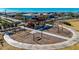 Aerial view of a community playground with swings, climbing structures, and landscaped surroundings at 4330 S Neutron --, Mesa, AZ 85212