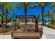 Community entrance sign with landscaping, mature palm trees, and a welcoming atmosphere at 4330 S Neutron --, Mesa, AZ 85212