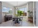 Bright dining area featuring a modern chandelier, large windows, and stylish decor at 4330 S Neutron --, Mesa, AZ 85212
