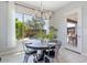 Bright dining area featuring a modern chandelier, large windows, and stylish decor at 4330 S Neutron --, Mesa, AZ 85212