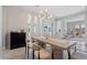 Elegant dining room with a contemporary table and chairs, stylish light fixture, and neutral decor at 4330 S Neutron --, Mesa, AZ 85212