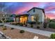 Charming home with landscaped front yard and covered front porch at dusk at 4330 S Neutron --, Mesa, AZ 85212