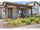 Inviting front porch with stone pillars, landscaping, and a cozy seating area at 4330 S Neutron --, Mesa, AZ 85212